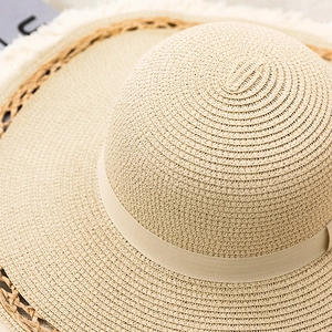 Women's wide brim straw sun hat with ribbon detail and frayed edge for beach outings