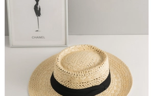 Close-up of finely woven Panama straw hat texture with elegant wide black ribbon band