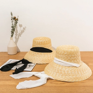Handwoven straw sun hat with elegant long ribbons in black and white colors