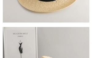 Detail of handwoven straw hat material with elegant black ribbon for sun protection