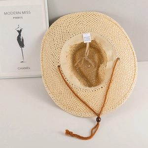 Detail of handmade straw cowboy hat featuring 100% paper weave and adjustable chin strap