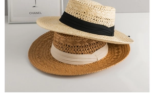 Detail of cross-weave texture on two summer Panama straw hats with decorative ribbons