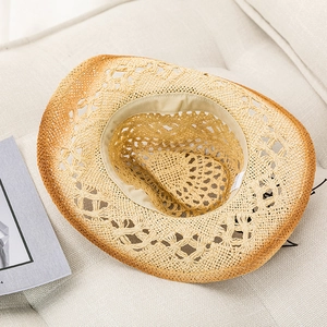Close-up of woven straw hat featuring breathable mesh crown and brown gradient brim detail