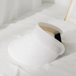 Close-up of white straw sun hat weave texture with black elastic band on white fabric