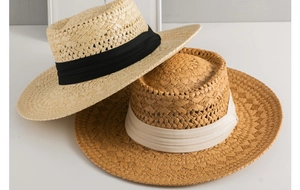 Detail of hand-woven straw Panama hats with decorative ribbons for sun protection