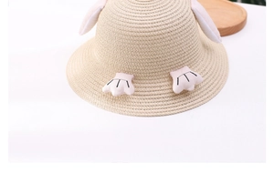 Close-up of cute children's penguin straw hat with 3D ears and pink paw decorations