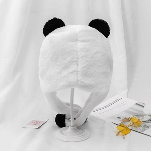 Detailed plush texture of winter panda earflap hat with black pompom and soft faux fur