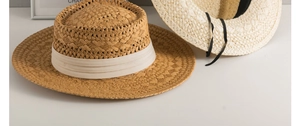 Close-up of natural woven straw texture on beige and cream Panama sun hats with bands