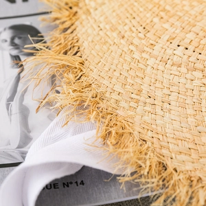 Macro shot of natural raffia straw hat material with frayed edges and fringe detail