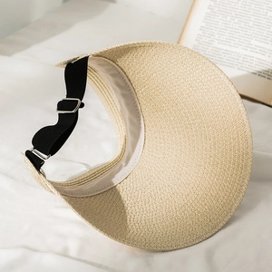 Detail of adjustable black elastic strap and silver buckle on a straw sun visor hat