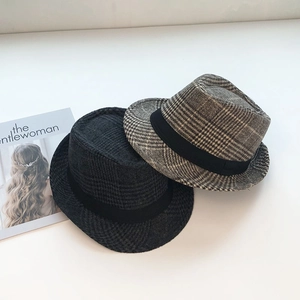 Classic wool fedora hats in solid black and brown plaid patterns with decorative ribbons