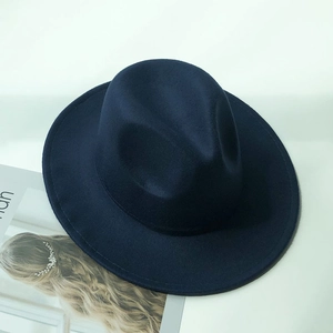 Close-up of a navy blue wool felt fedora hat featuring detailed stitching on the brim