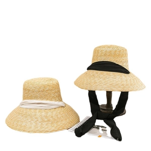 Elegant woven straw sun hats with chic black and ivory ribbons for women's summer travel