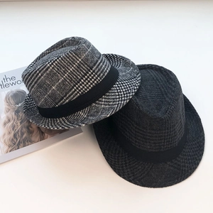Detail view of vintage plaid and black wool fedora hats with grosgrain ribbon band