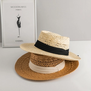 Handwoven straw Panama hats for sun protection in beige and tan colors on white background