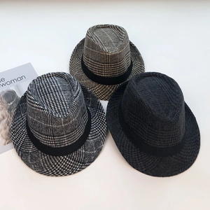 Close-up of three vintage checkered fedora hats in grey and brown wool blend fabric