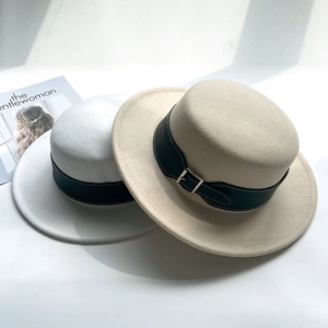 Close-up of wool fedora hats featuring black leather decorative belts and metal buckles