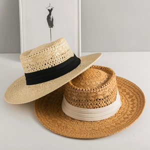 Handmade woven Panama straw hats for sun protection featuring elegant black and white ribbons