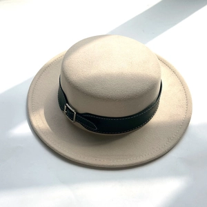 Detail of wool felt flat top boater hat with black leather belt and silver buckle detail