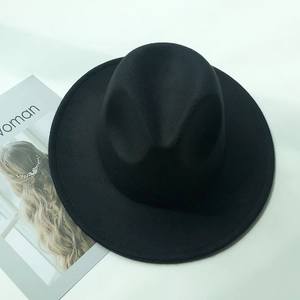 Minimalist black wide brim wool felt fedora hat shown from top view on white background
