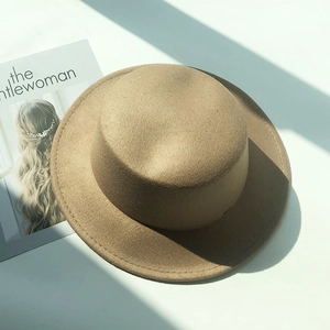 Detail of khaki wool felt boater hat showing fine stitching and stiff brim craftsmanship