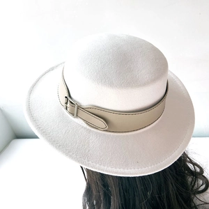 Detail of white wool felt boater hat with beige leather band and silver metal buckle
