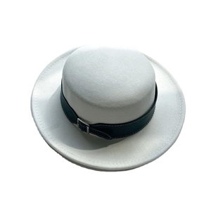 White wool boater hat with black ribbon and silver buckle in a vintage French style