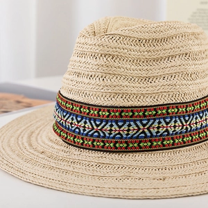 Close-up of woven straw fedora hat featuring a colorful bohemian style ethnic band