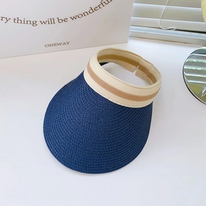 Detail view of woven straw sun visor hat with striped elastic headband in navy blue
