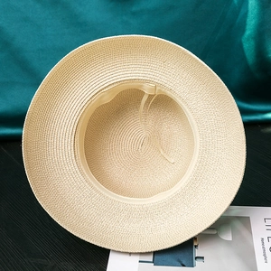 Close-up of summer straw hat interior with sweatband and adjustable drawstring