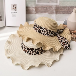 Summer straw hats with leopard print ribbon and wavy brim for sun protection