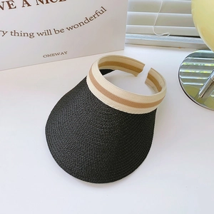 Detailed close-up of woven black straw sun visor hat with striped elastic headband