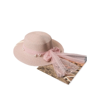 Pink straw boater hat with mesh bow and pearl details for sun protection