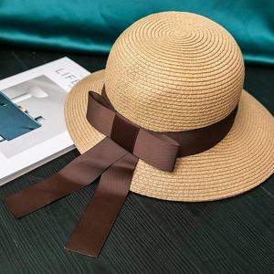 Hepburn style wide brim straw sun hat with elegant brown ribbon bow for beach vacation