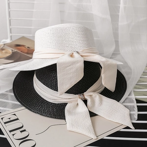 Flat top straw sun hats with rhinestone ribbon bows in black and white styles