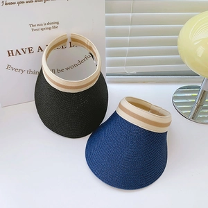 Detail of summer straw sun visor with elastic striped band in black and navy blue