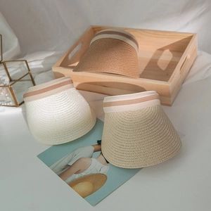 Women's summer straw sun visors in tan, white, and beige with striped ribbon detail
