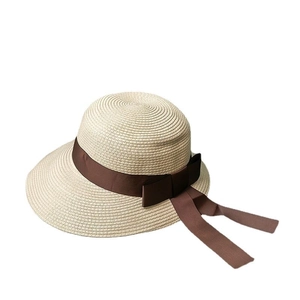 Elegant wide brim straw beach hat with deep brown ribbon bow for women summer vacation