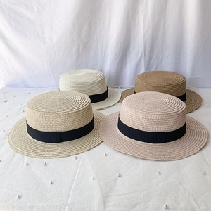 Classic straw boater hats in cream, beige, brown and pink with black grosgrain ribbon decor
