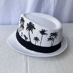 Detailed macro view of white woven fedora hat featuring black palm tree embroidery pattern