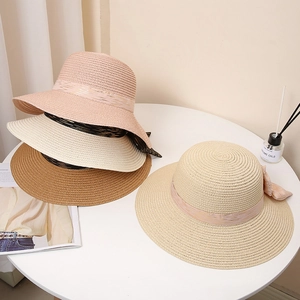 Elegant wide brim straw sun hats with ribbon bows in multiple summer colors