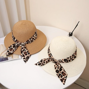 Straw sun hat with leopard print bow ribbon in natural wood and cream white colors