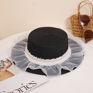 Flat top black straw hat with white organza ruffles and pearls for a vintage french look