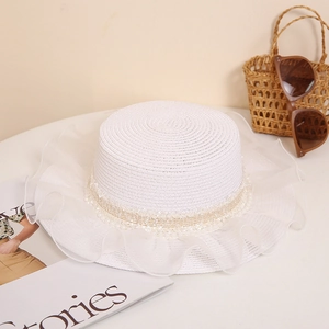 White flat top straw hat with tulle ruffle trim and bead detail for beach sun protection