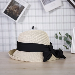 Elegant beige straw cloche hat for women featuring a wide black satin ribbon bow detail