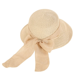 Beige wide-brim woven straw hat with a large ribbon bow for beach sun protection