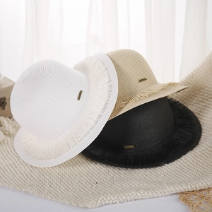 Straw sun hats with tassel edges in white, beige, and black colors for beach travel