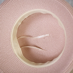 Detail of pink straw sun hat inner lining with adjustable silk ribbon and sweatband