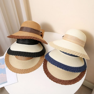 Women's summer straw sun hats with elegant bow ribbons and wavy textured brims in multiple colors