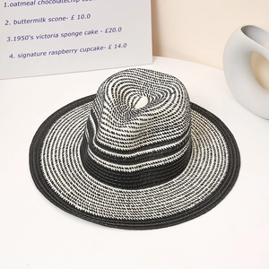 Detail of black and white striped woven straw fedora hat with elegant spiral texture